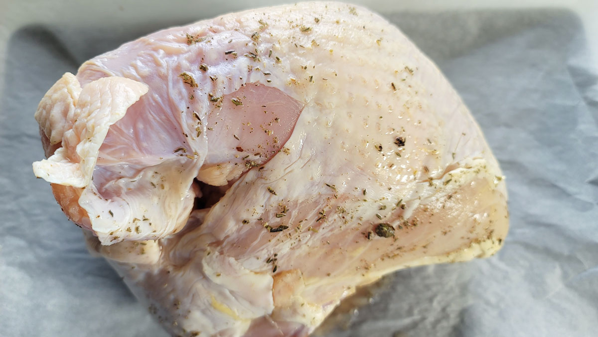 Brined breast on a piece of parchment.