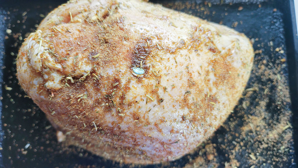 Seasoned bird rubbed with the spice mixture.