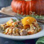 Stuffing from stuffed turban squash with a whole squash in the background.