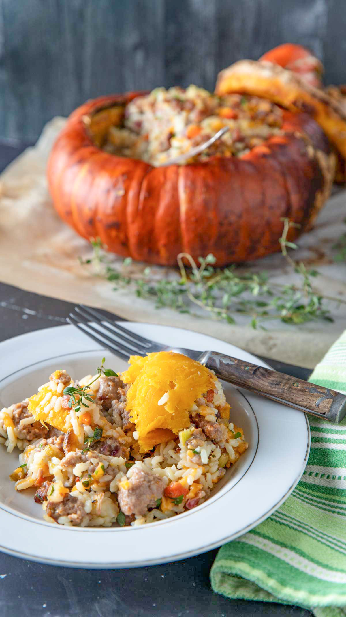 A bowl of turban squash with a stuffed squash in the background.