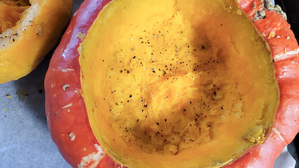 Inside of the squash drizzled with olive oil and seasoned with salt and pepper.