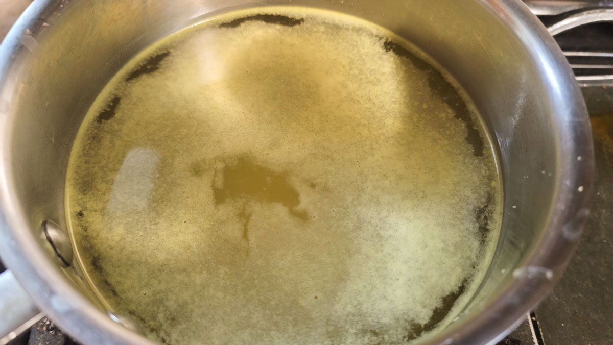 Chicken stock in a small saucepan.
