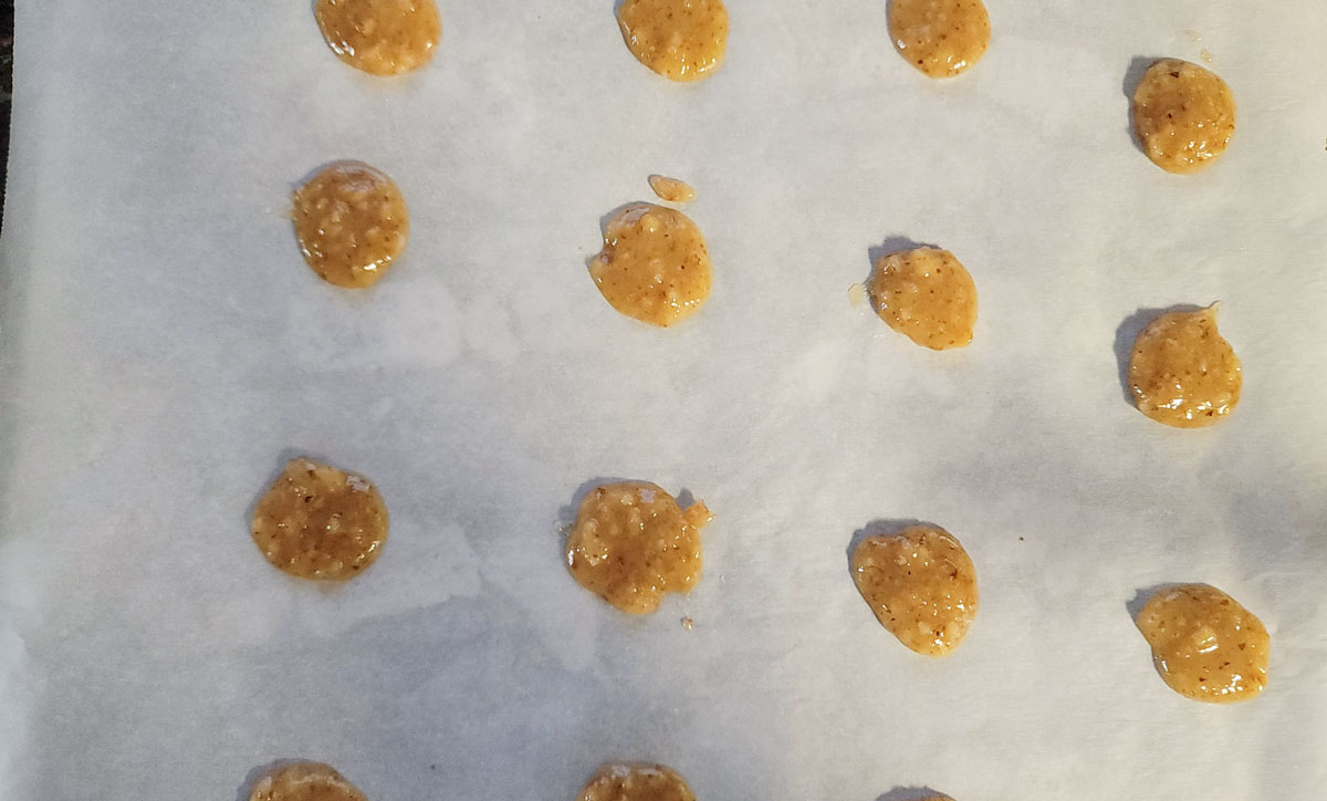 Batter placed on a cookie sheet on top of parchment paper.