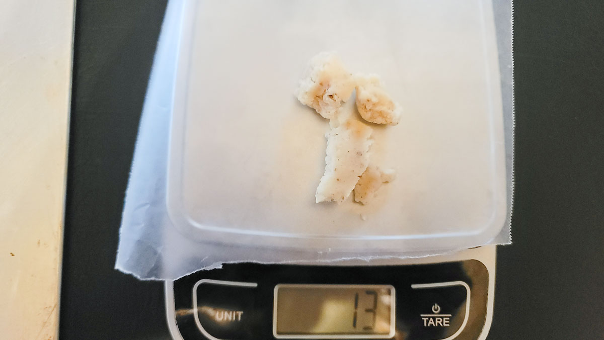 Chunks of dough being weighed on a scale.