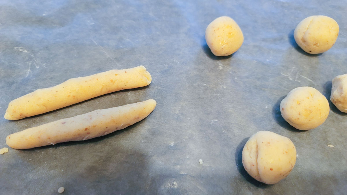 Dough rolled into balls and then ropes.