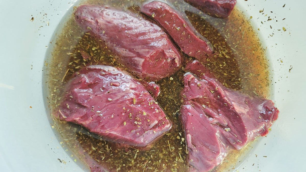 Steaks added to the marinade.