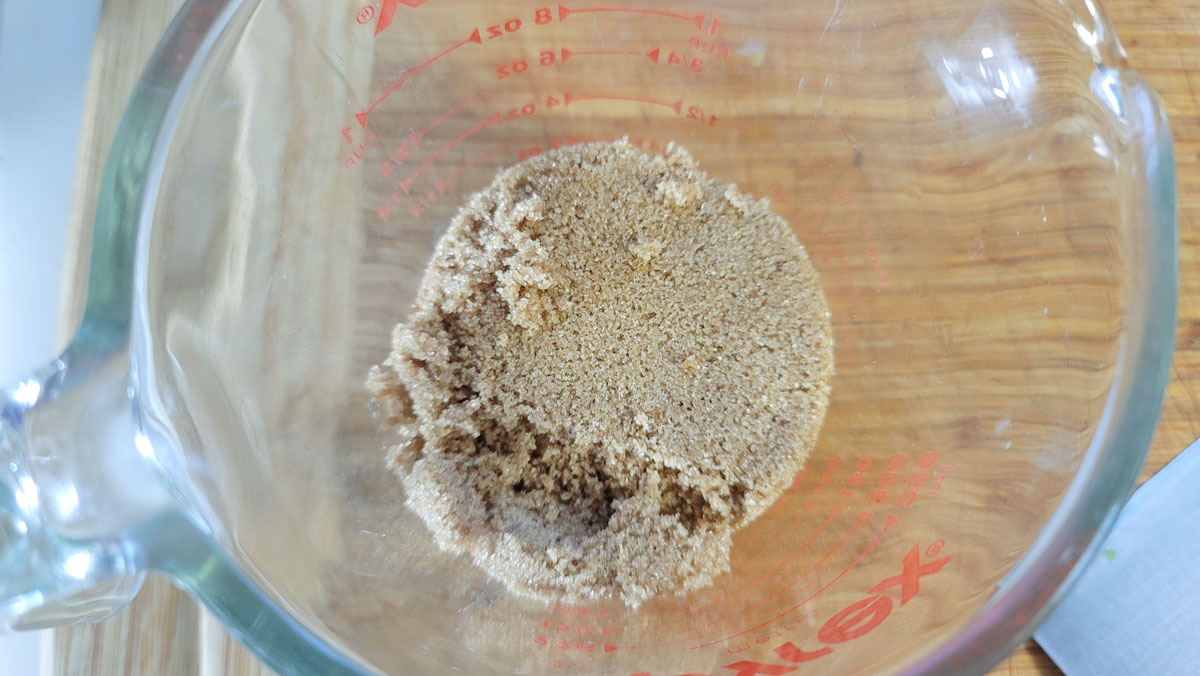 Brown sugar in a measuring cup.