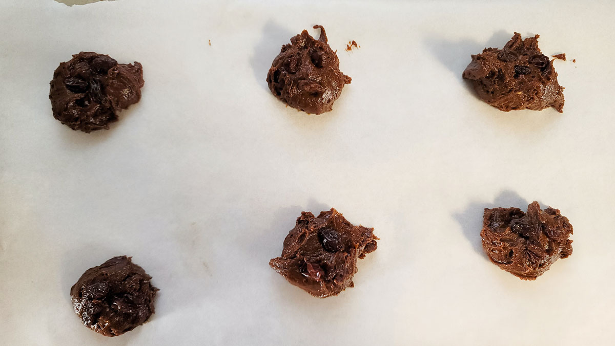 Spoonfuls of dough on a cookie sheet.