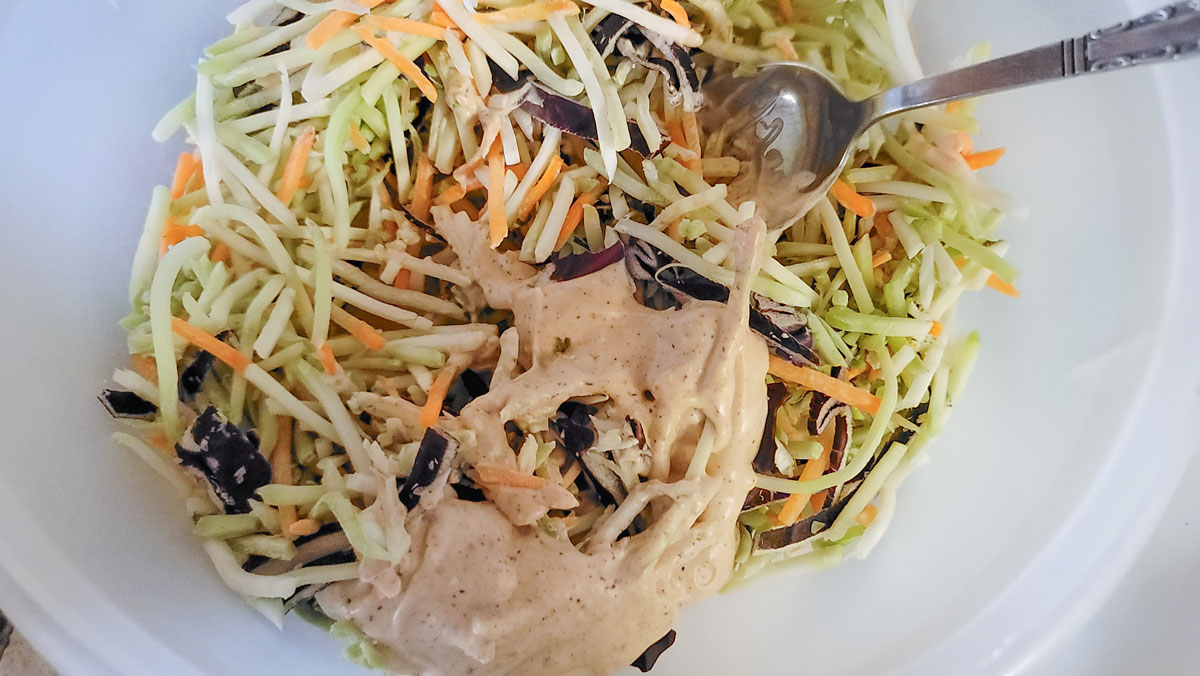 Dressing added to cabbage mix.