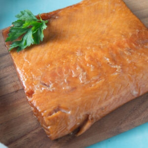 Smoked salmon on a wooden board.