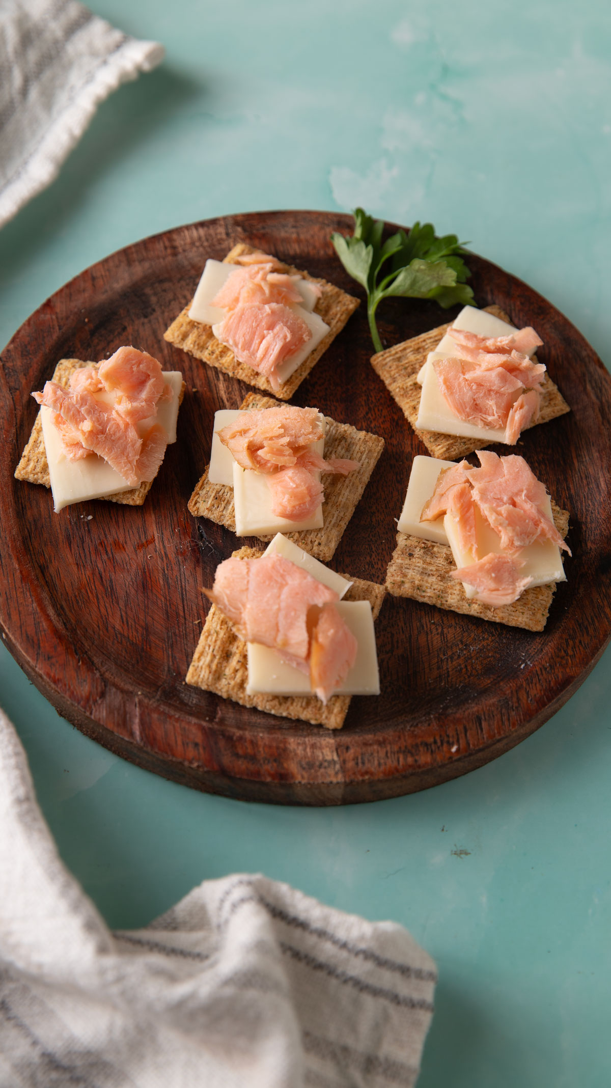 Smoked salmon appetizers on a wooden plate.
