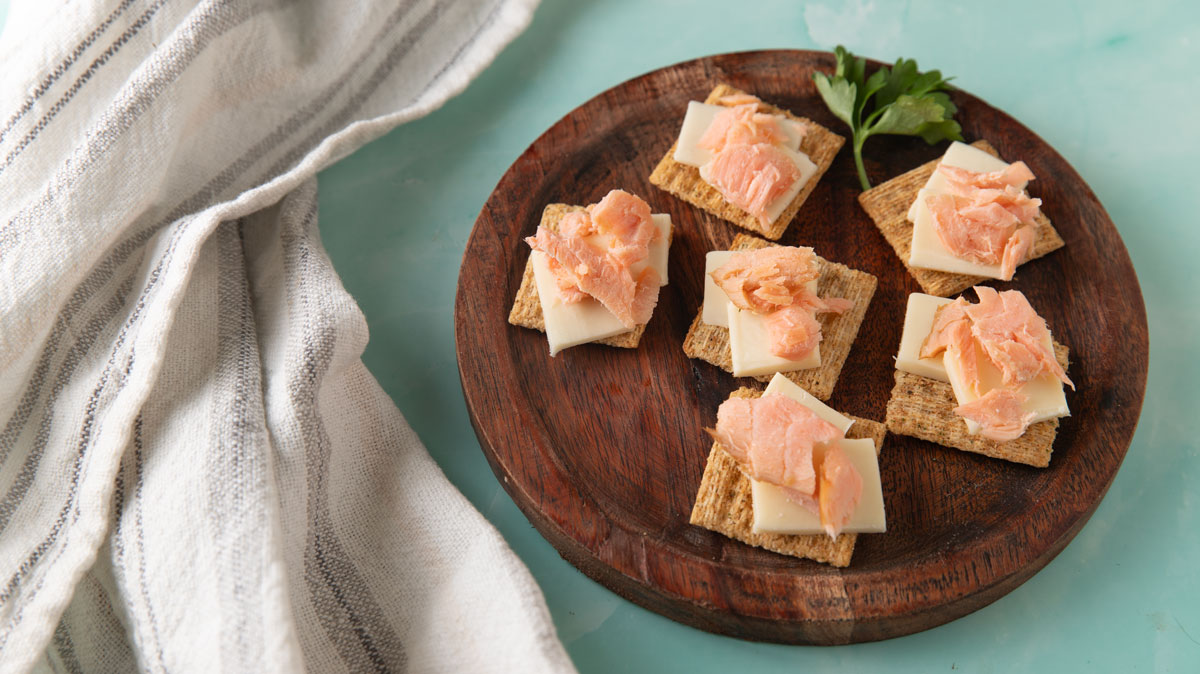 Smoked salmon on a cracker with cheese.