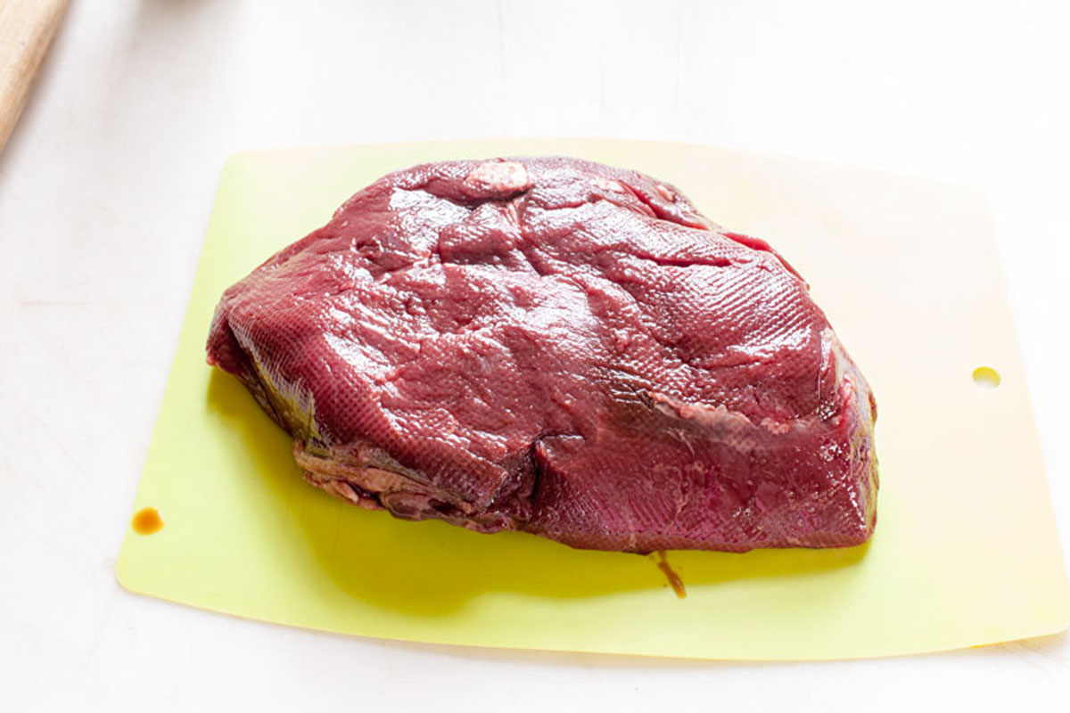 Venison steak on a cutting board.
