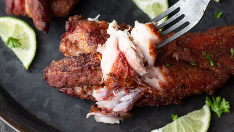 Breaking off flaky fish with a fork.