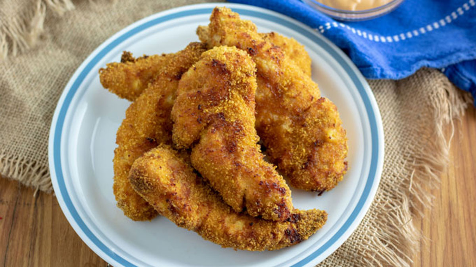 Chicken tenders on a plate.