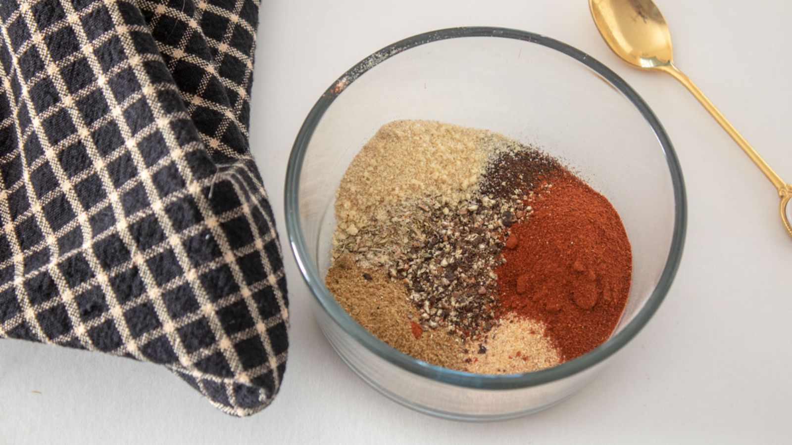 Adobo seasoning in a glass bowl.