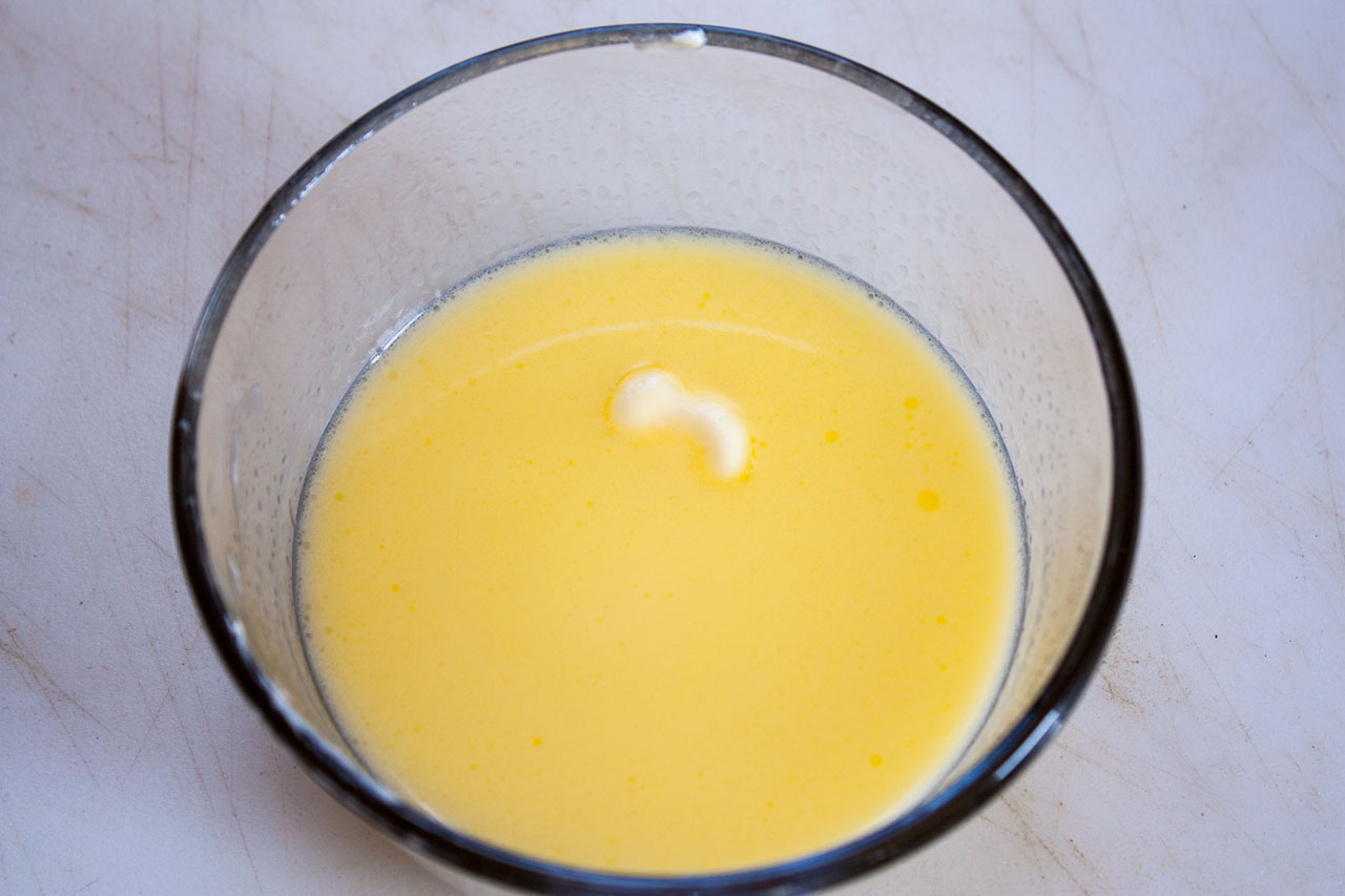 Melted butter in a small bowl.