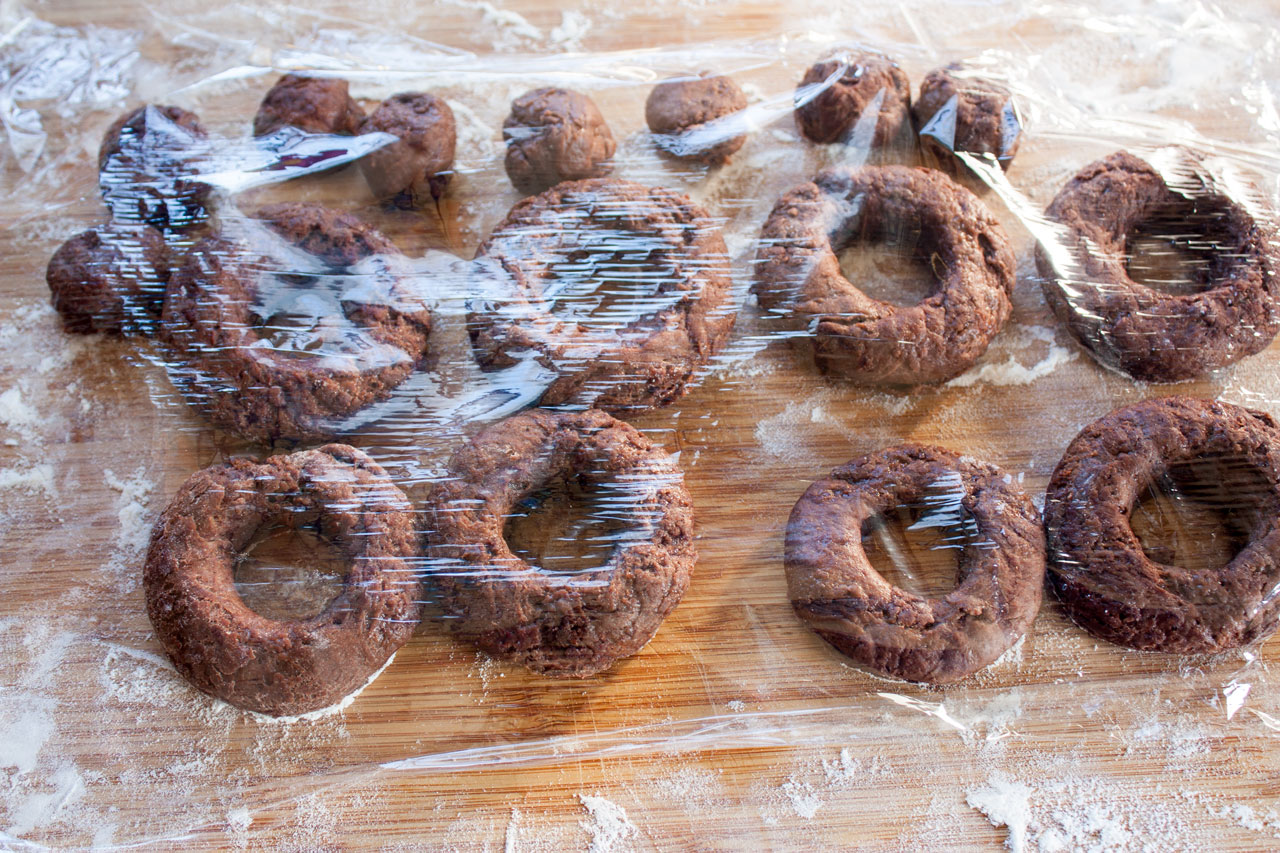 Doughnuts covered with plastic wrap.