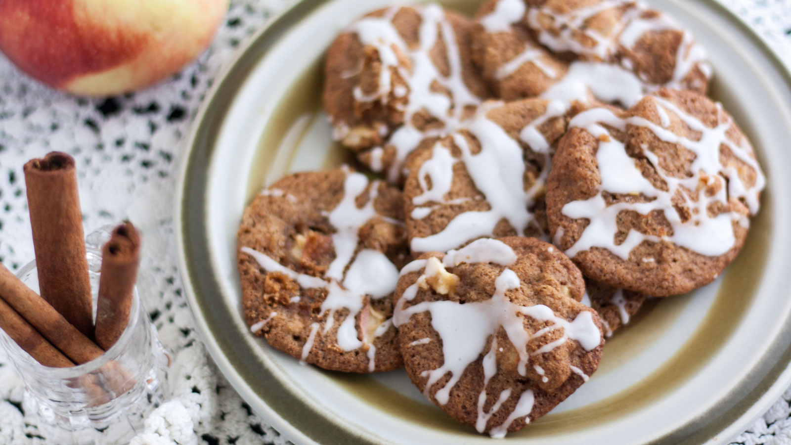 Apple cookies with cinnamon sticks on the side.