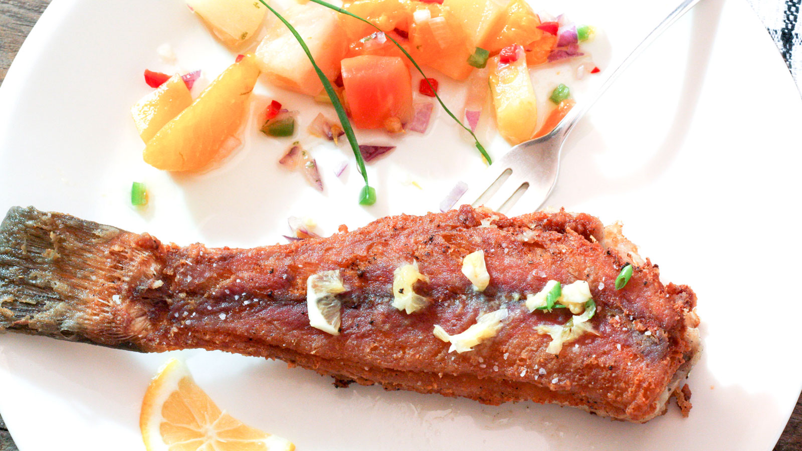 Fried bullhead fish served with a colorful salsa.