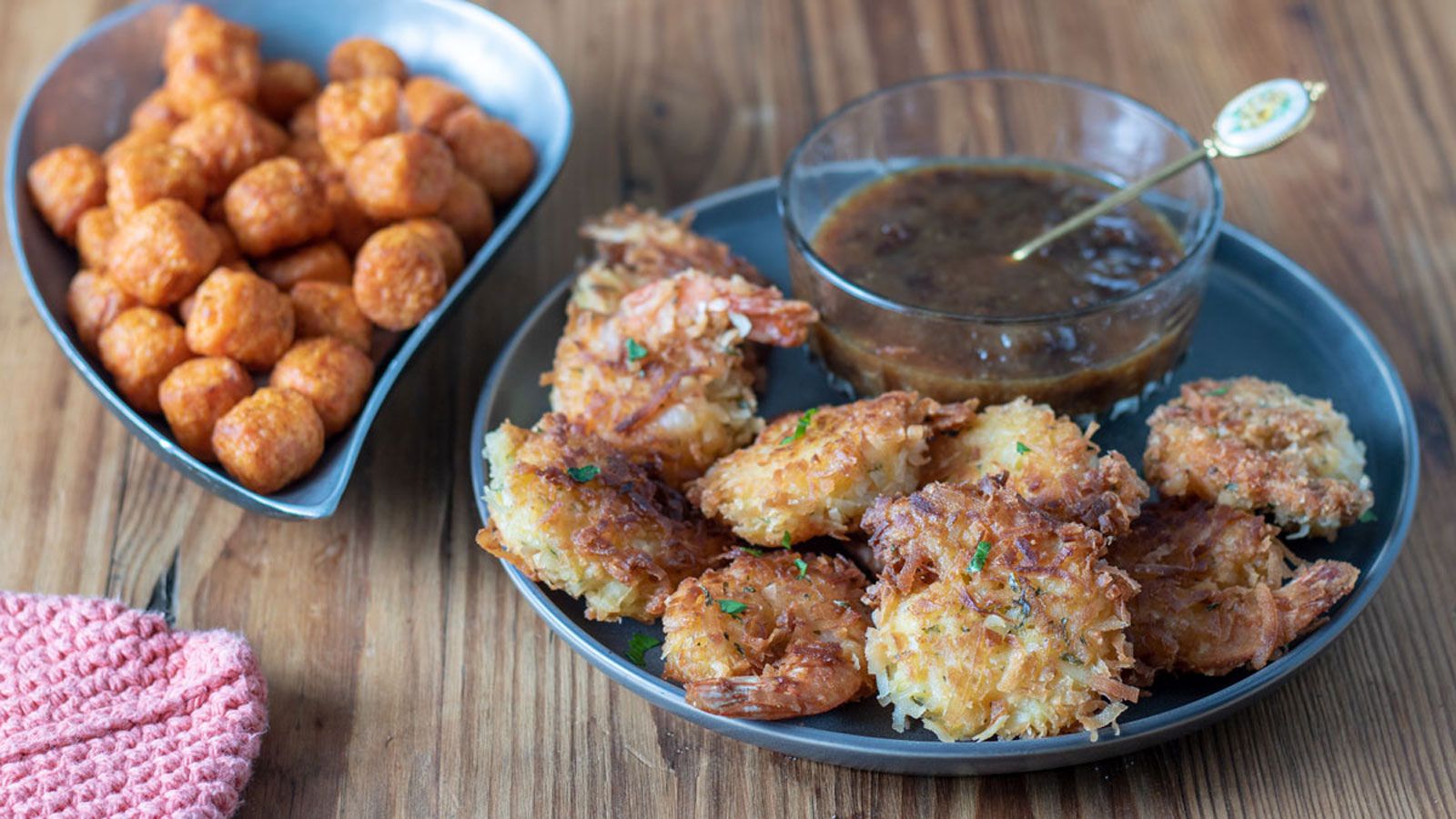 Coconut shrimp on gray plate with dipping sauce