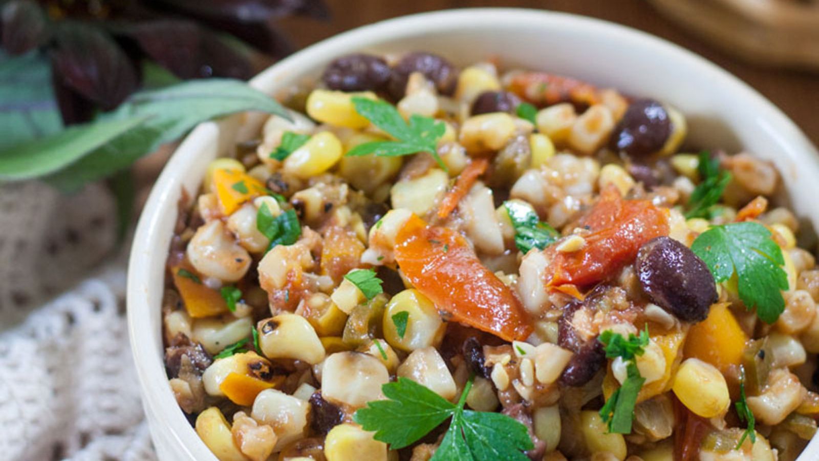 Colorful bowl of corn bean salsa topped with cilantro