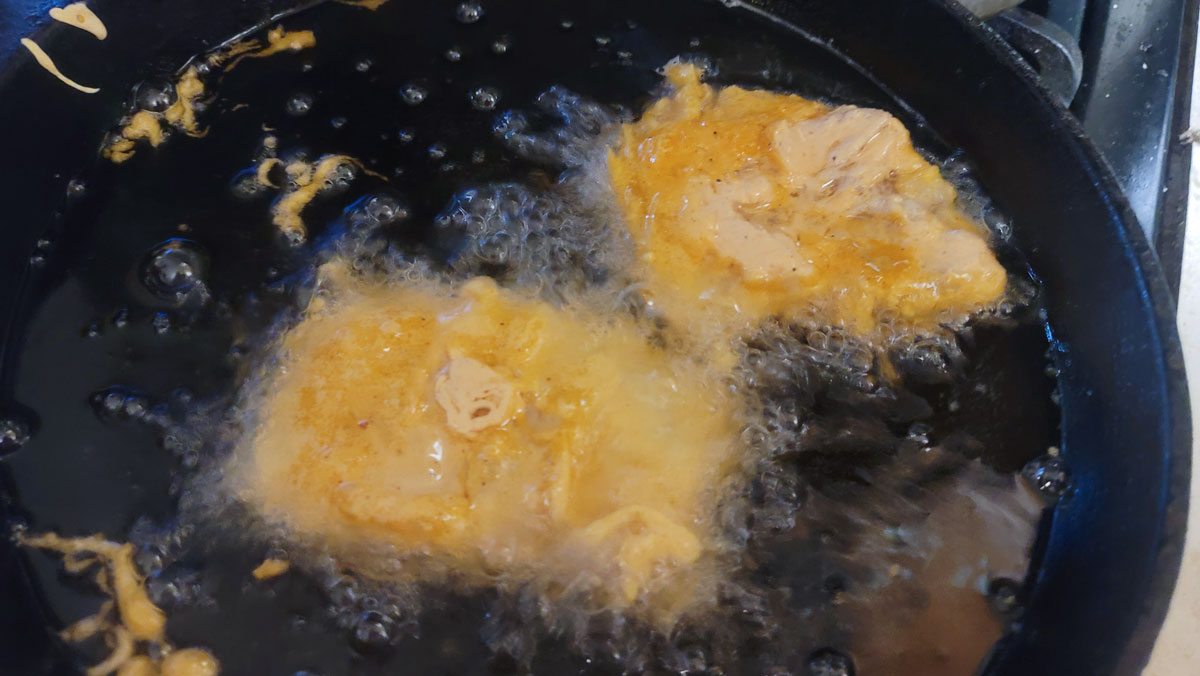 Fish frying in oil.