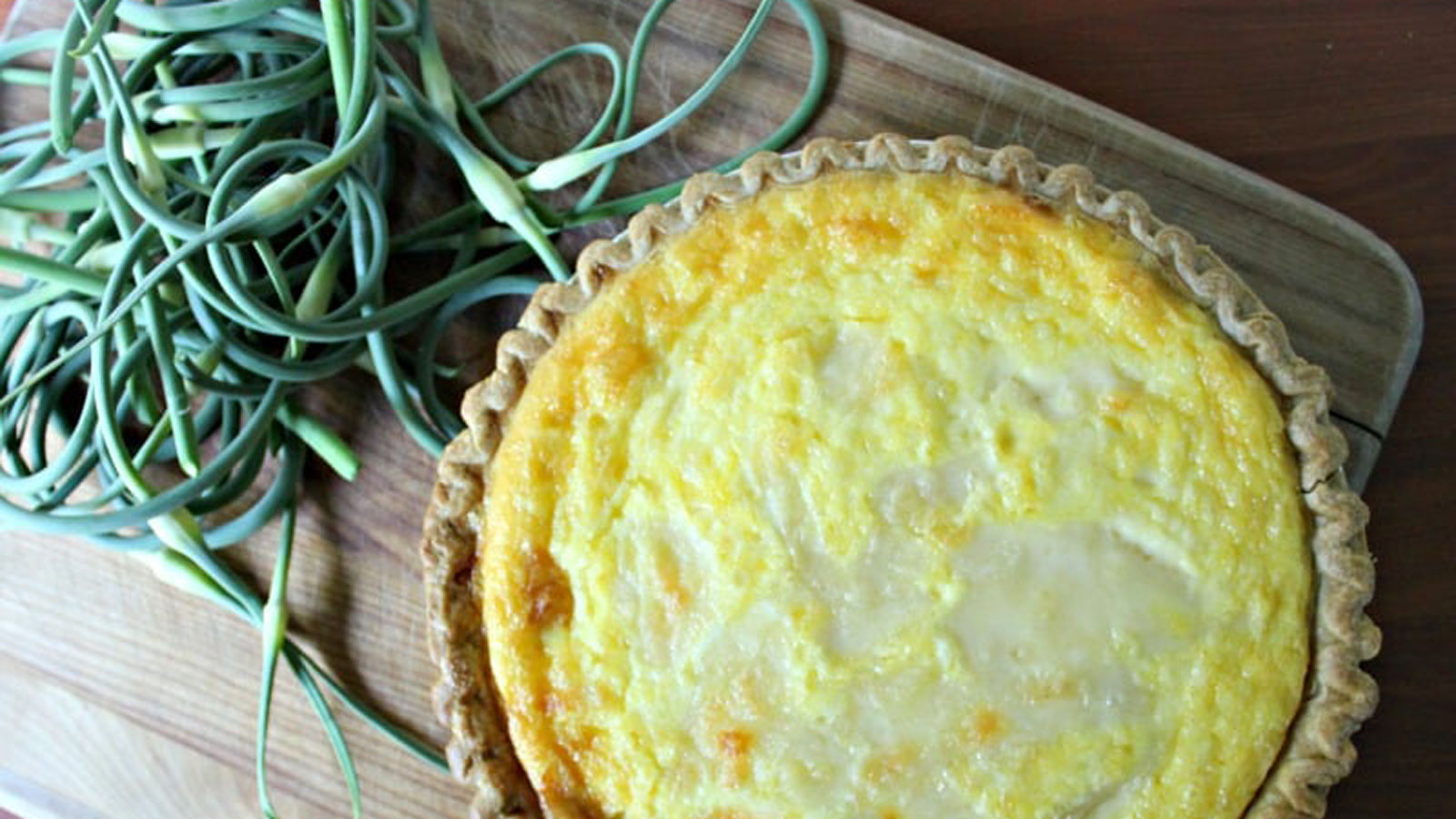 Baked quiche with garlic scapes on the side.