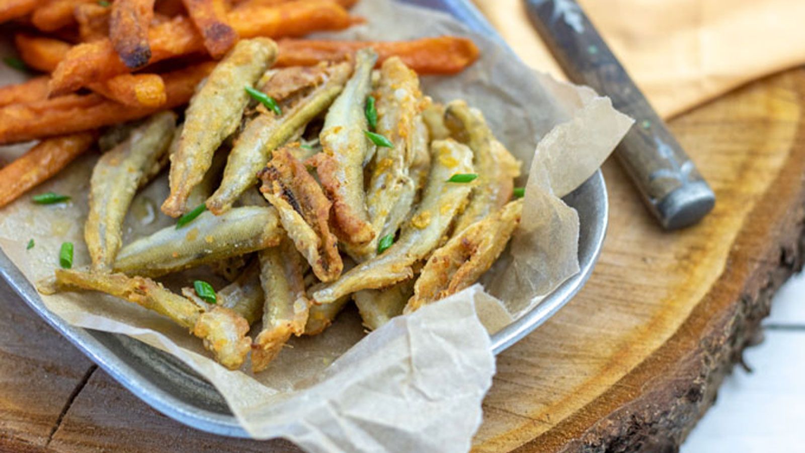 Fried smelt on pewter dish with sweet potato fries.