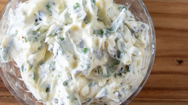 Garlic scape butter in a glass bowl.