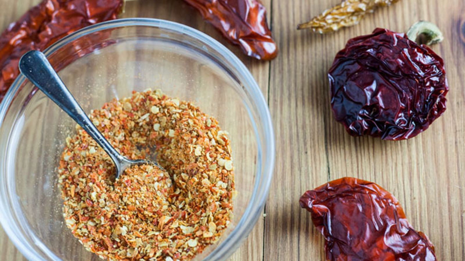 Small flakes of dried habanero pepper in a glass bowl.