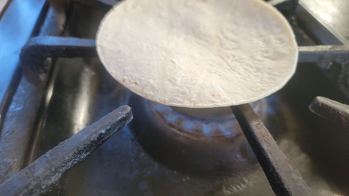 Tortilla set on top of a gas store fire.