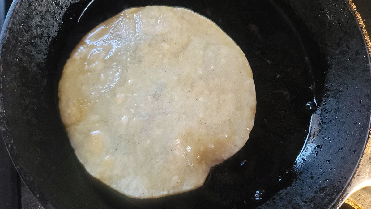 Flipped tortilla in the oil to heat the other side.