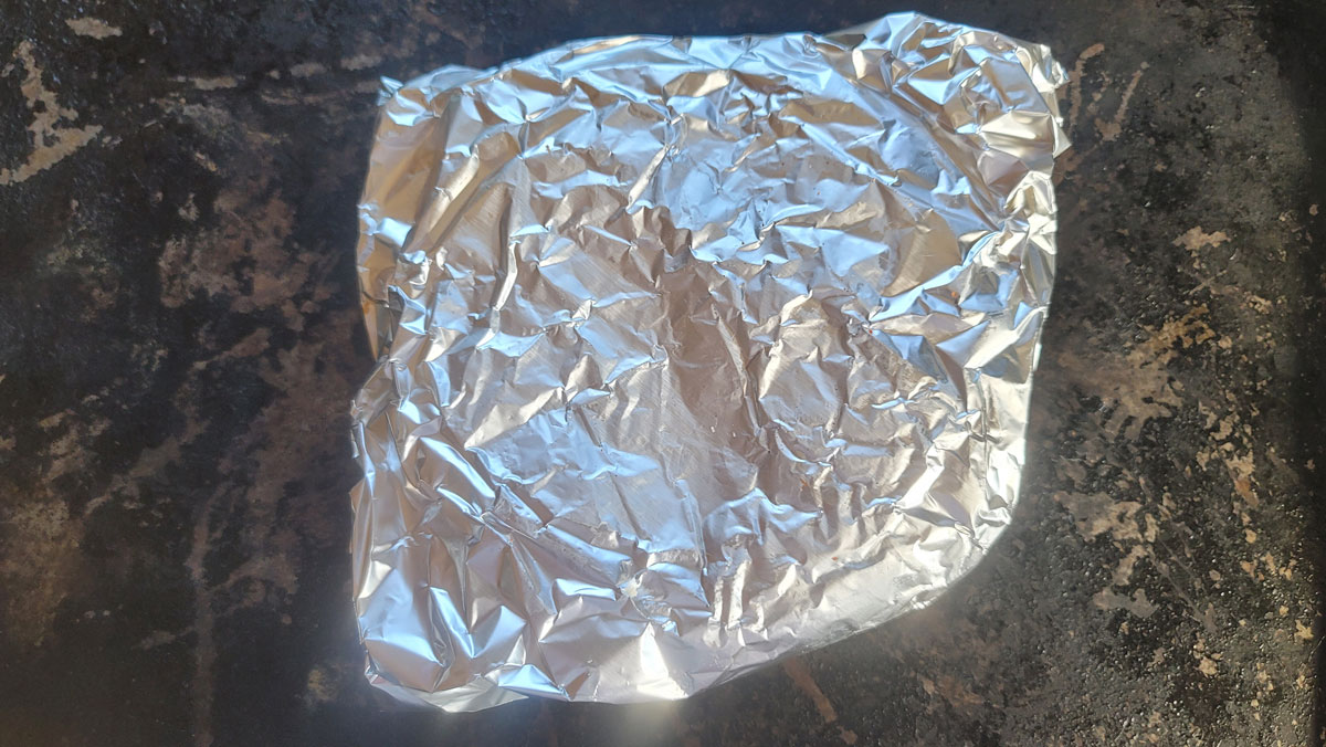 Foil packet set on a baking sheet.