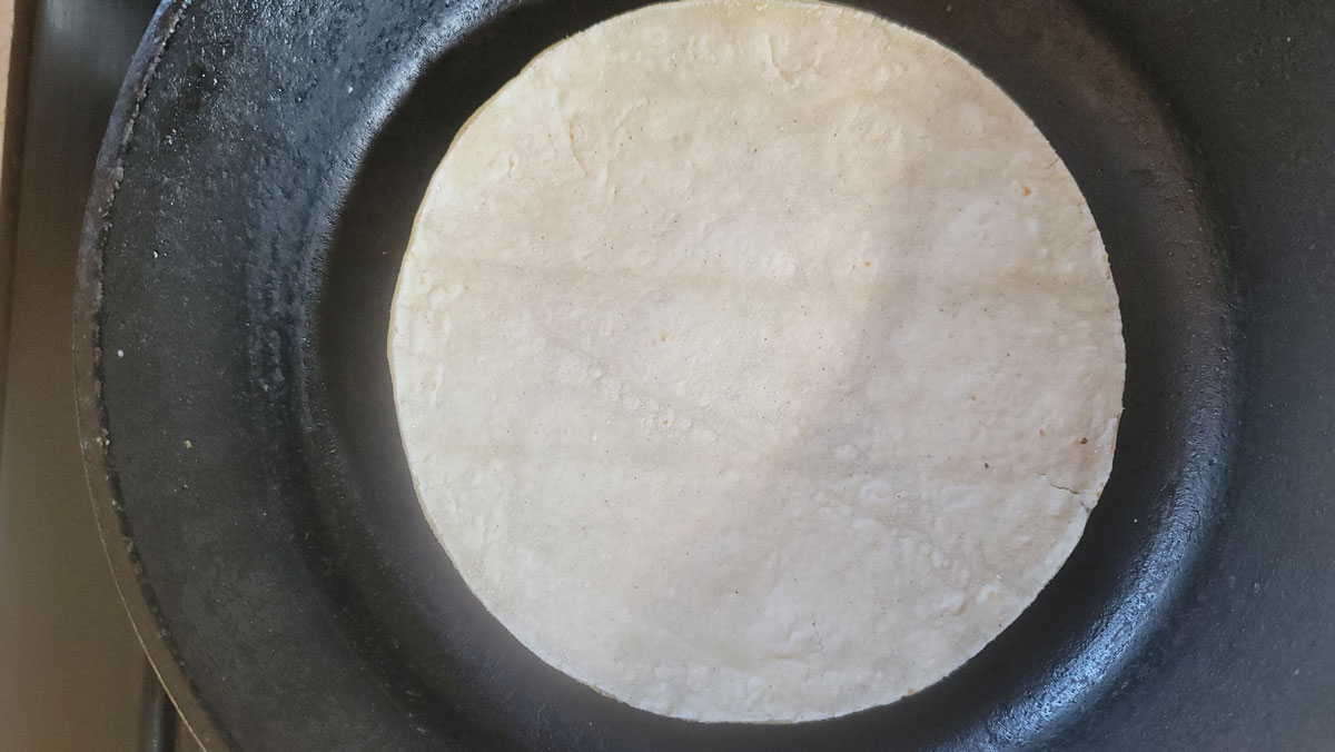 Shell in the center of a small cast iron frying pan.