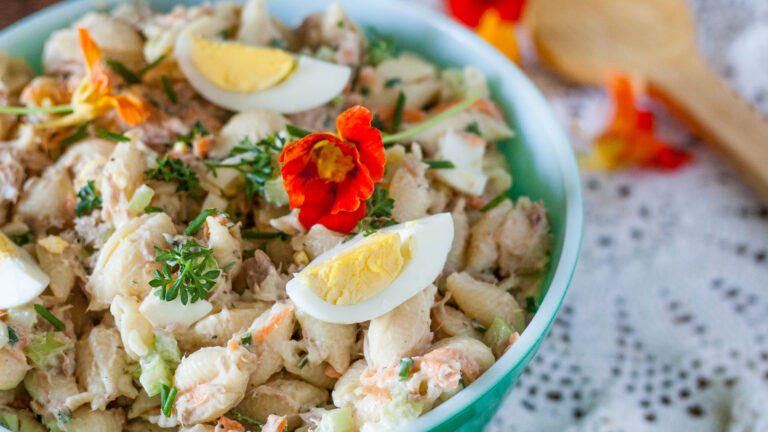 Macaroni tuna salad in a bowl with egg.