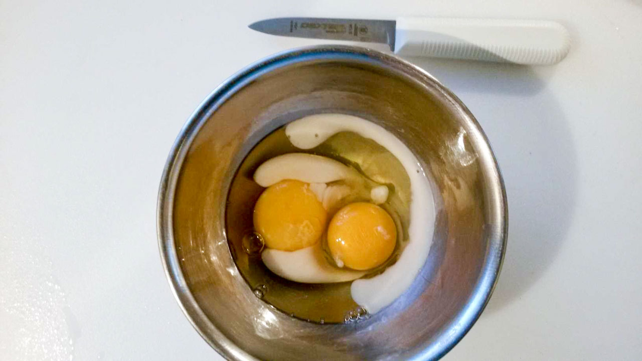 Eggs and milk in a bowl.