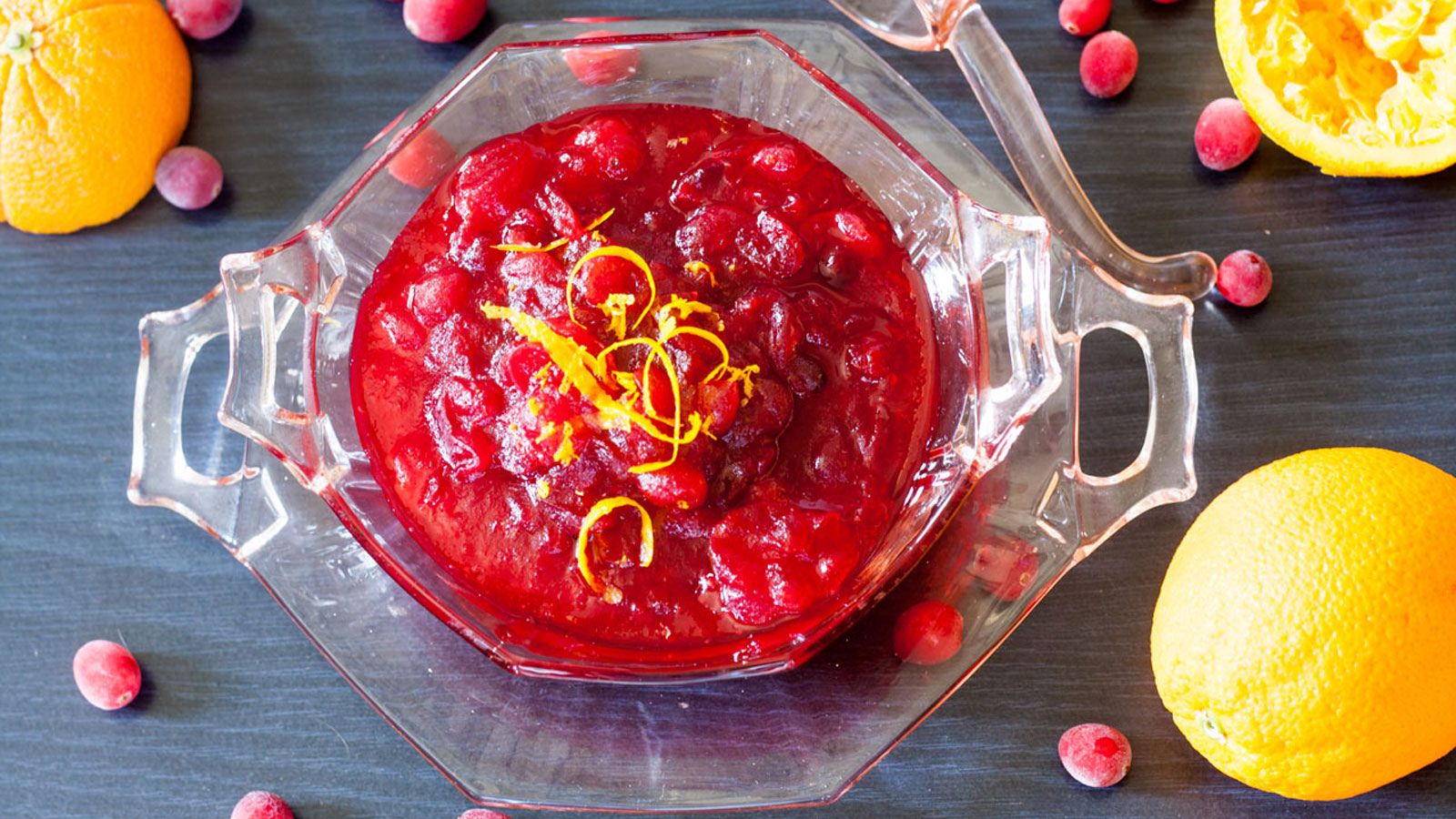 Bowl of citrus (orange) cranberry sauce garnished with orange zest shavings.