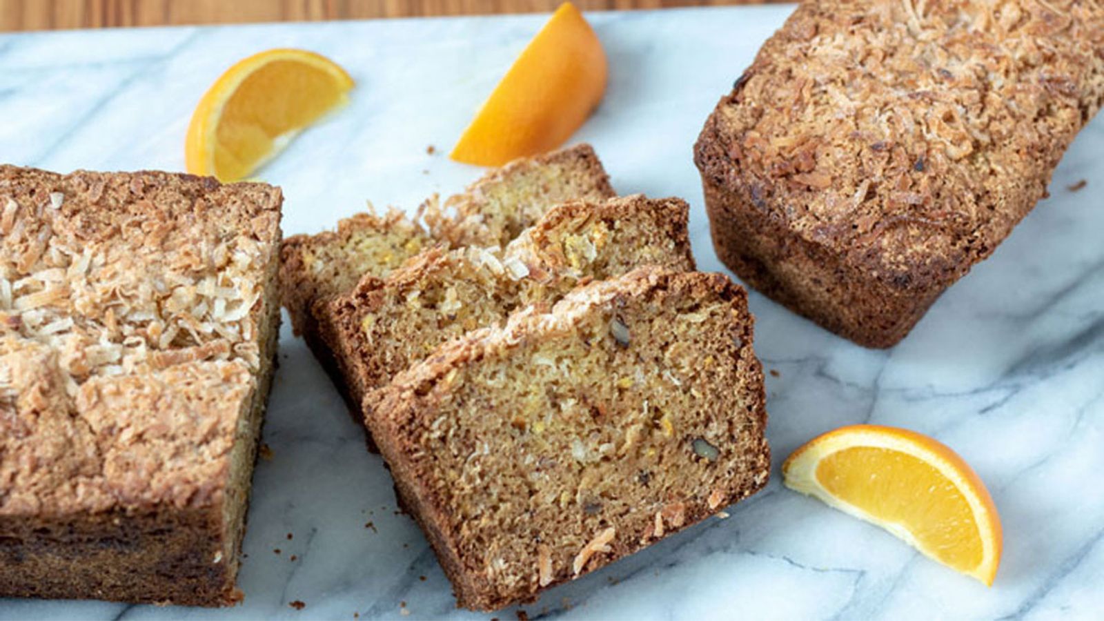 Slices of coconut bread on marble board.