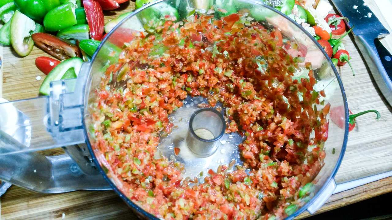 Chopped veggies in food processor bowl.