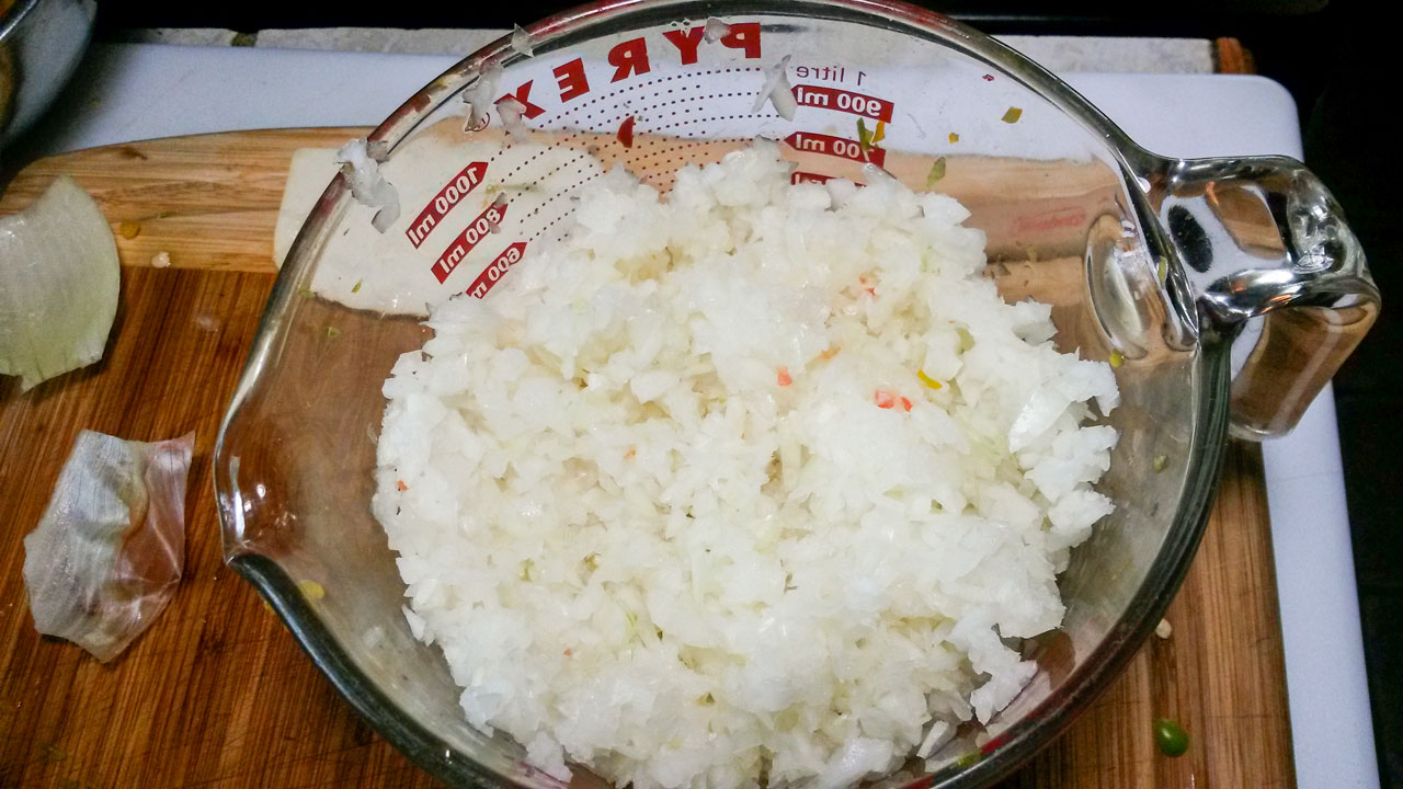 Chopped onions in a large measuring cup.