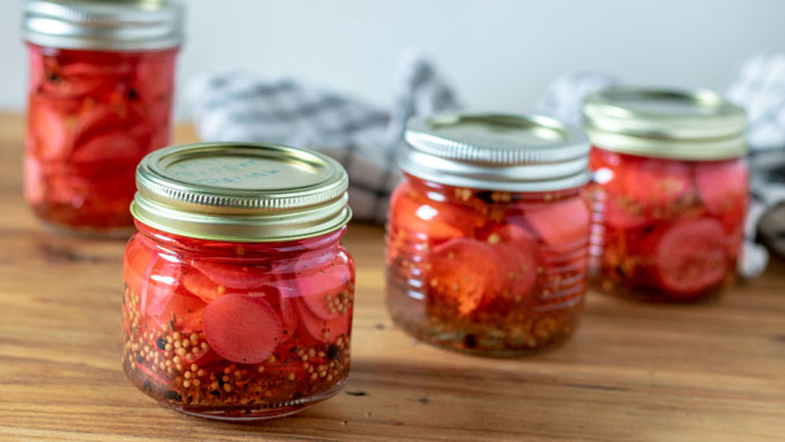 Four jars of pickled radishes.