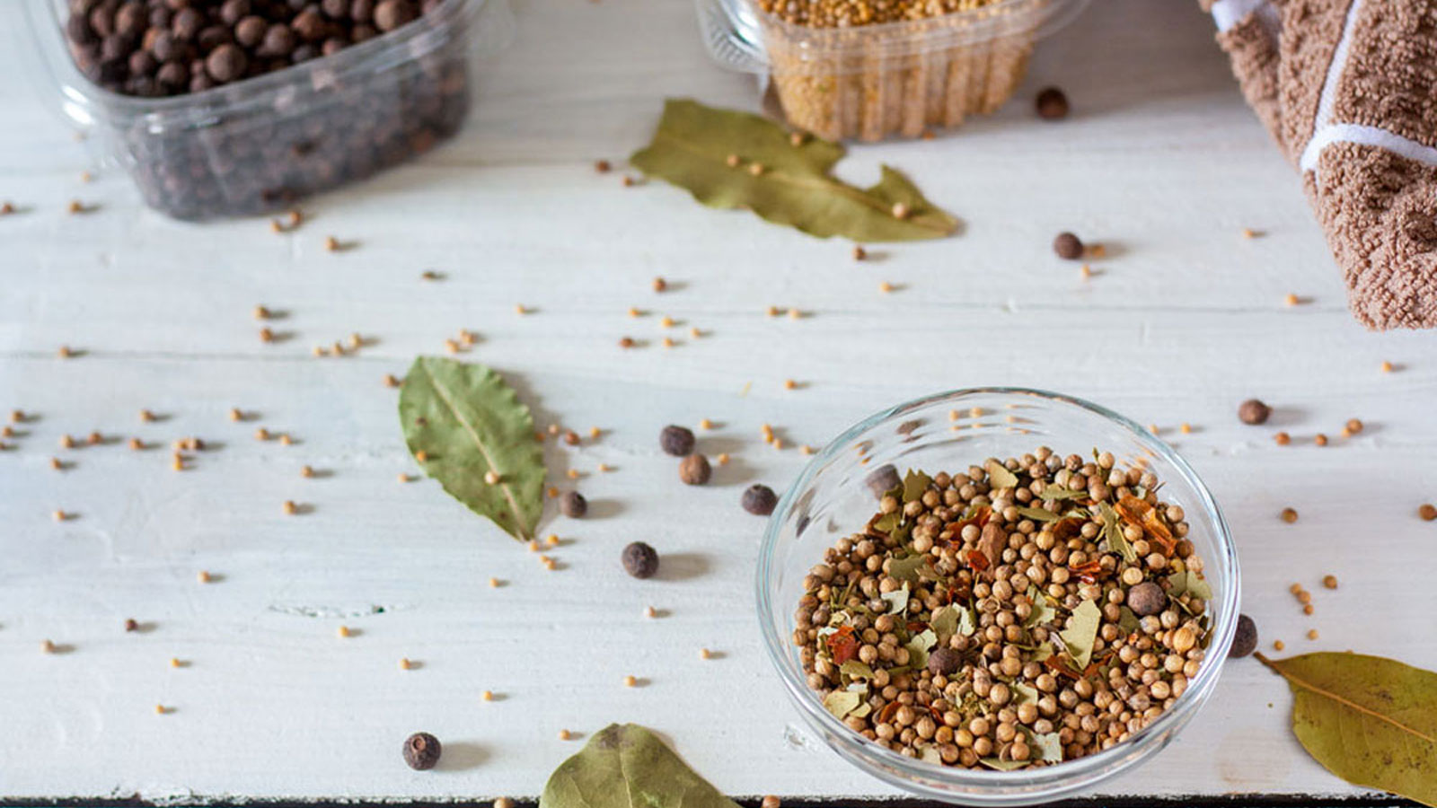 Homemade pickling spice with various spices in boxes.