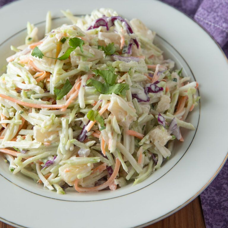 White bowl mounded with Pineapple Coleslaw.