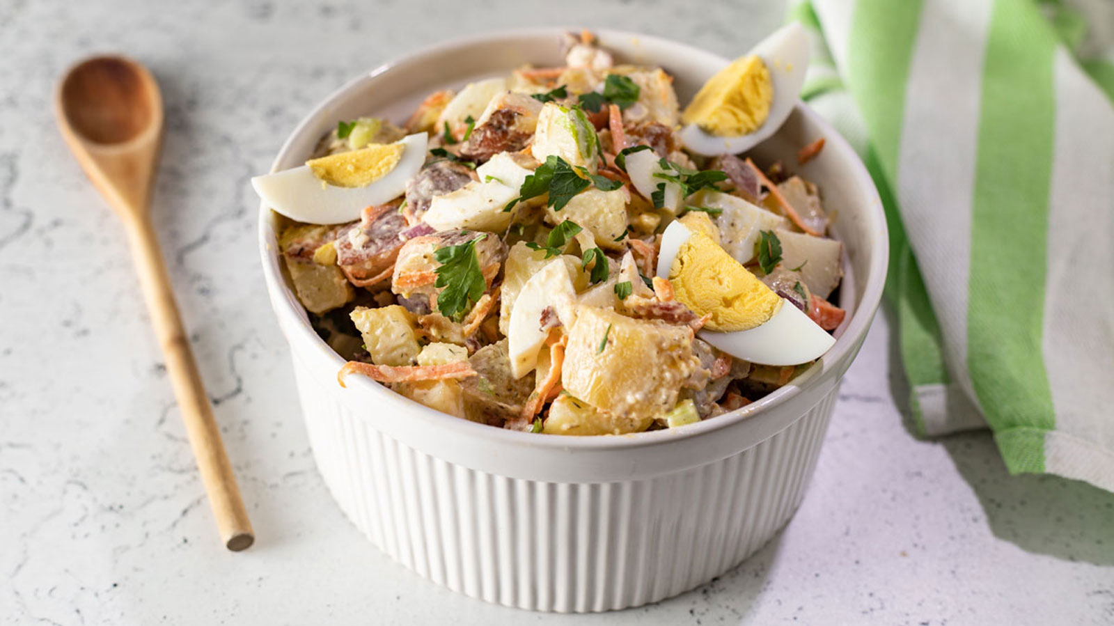 Bacon and egg potato salad with egg slices.