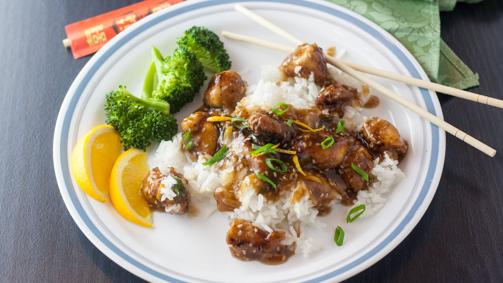 Sesame chicken on a bed of steamed rice with broccoli.