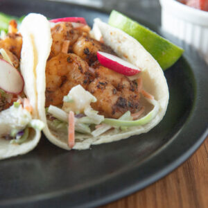 Close up of shrimp tacos with pineapple slaw.