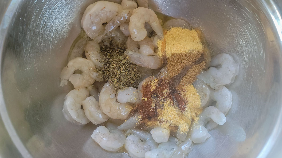Spices and shrimp in a bowl.