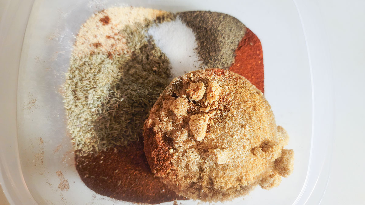All dry rub ingredients added to a bowl.