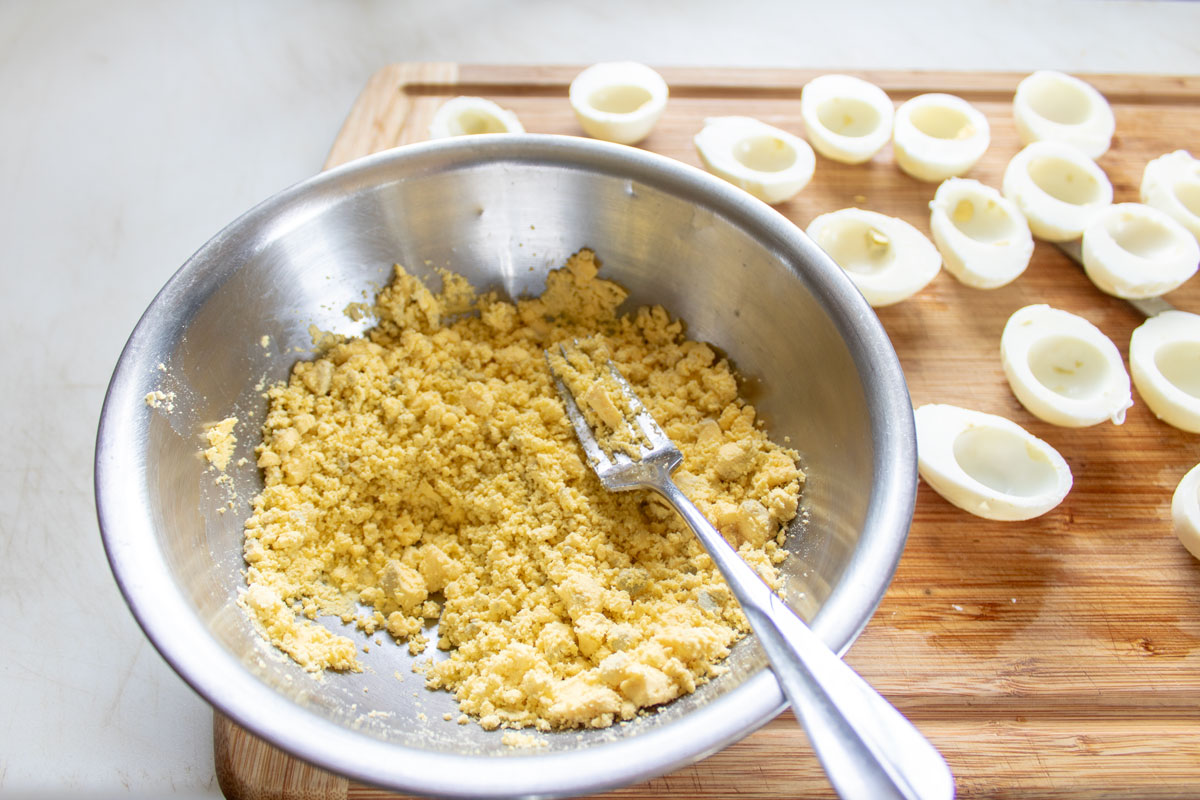 Mashed egg yolks with a fork.